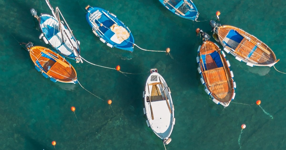 un grupo de barcos en las aguas cristalinas de las Cinque Terre