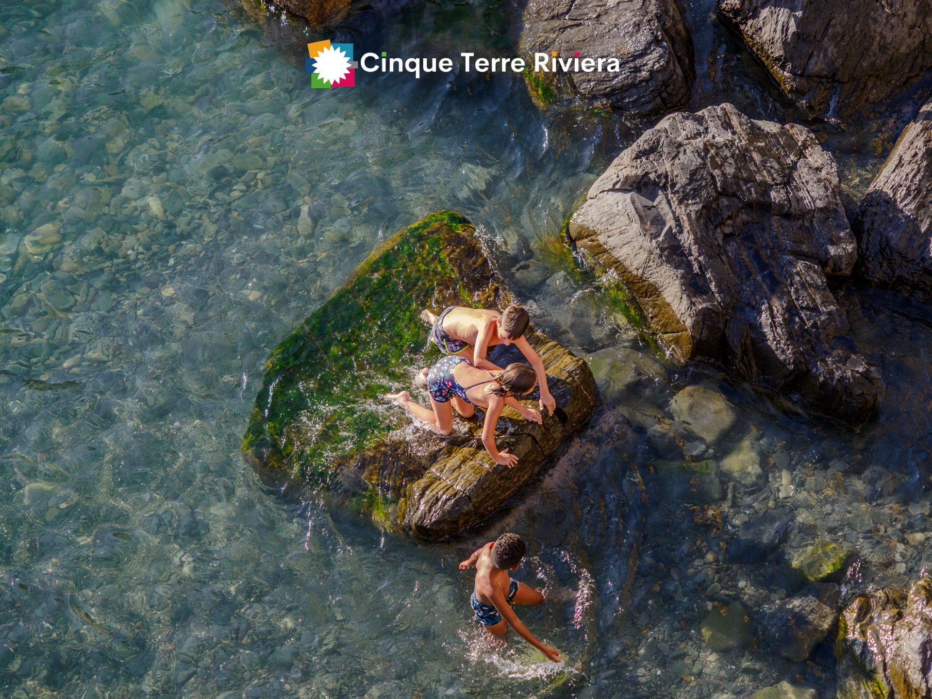 children playing in Vernazza waters at sunset