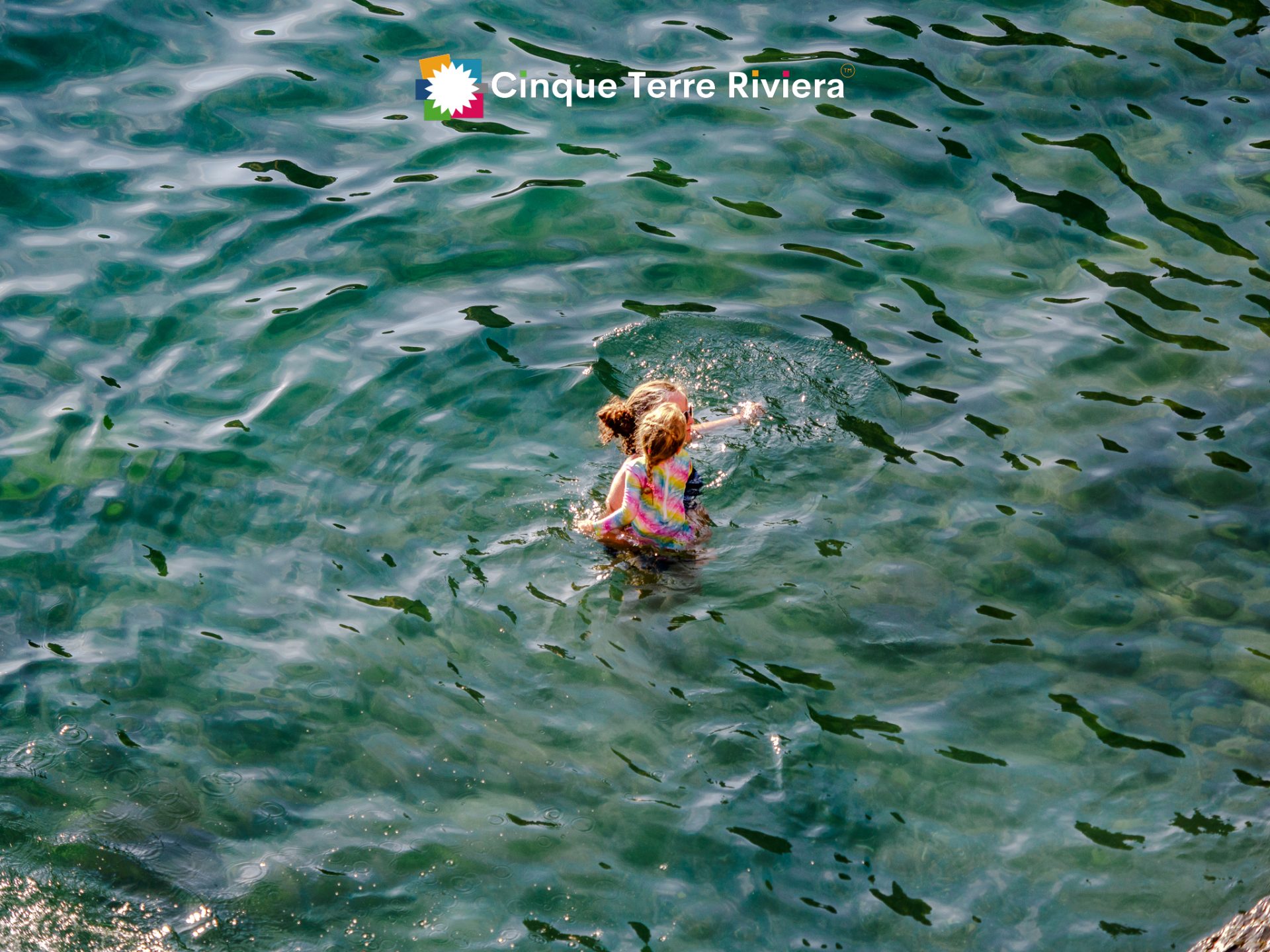mother and little daughter enjoying a morning swim in Vernazza